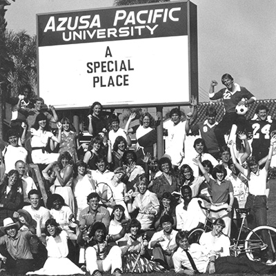apu students from the past in black and white in front of a azusa pacific sign