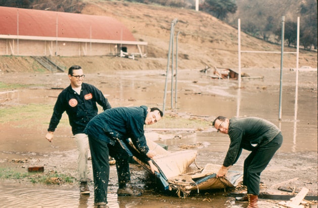 Faculty helping clean debris after the flood