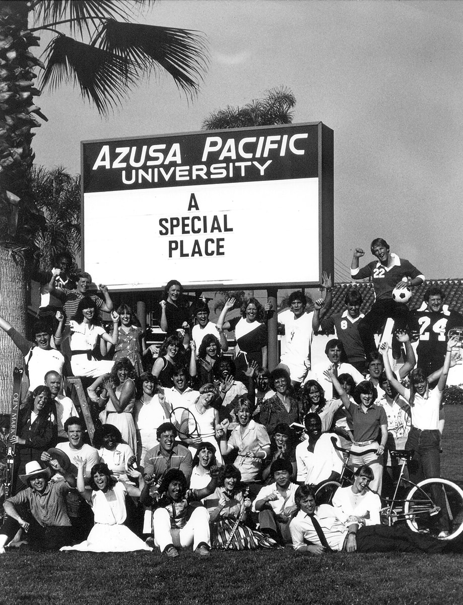 Students and faculty posing in front of new Azusa Pacific Universitysign