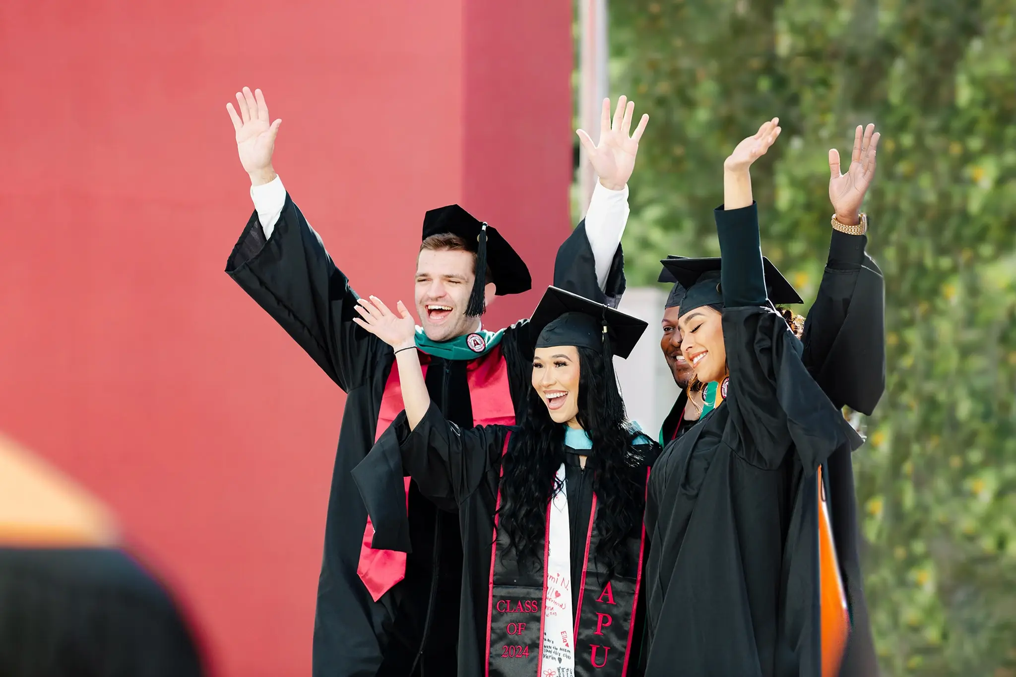 students during commencement wearing cap and gown
