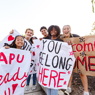 apu students smiling and holding a customize poster during welcome weekend