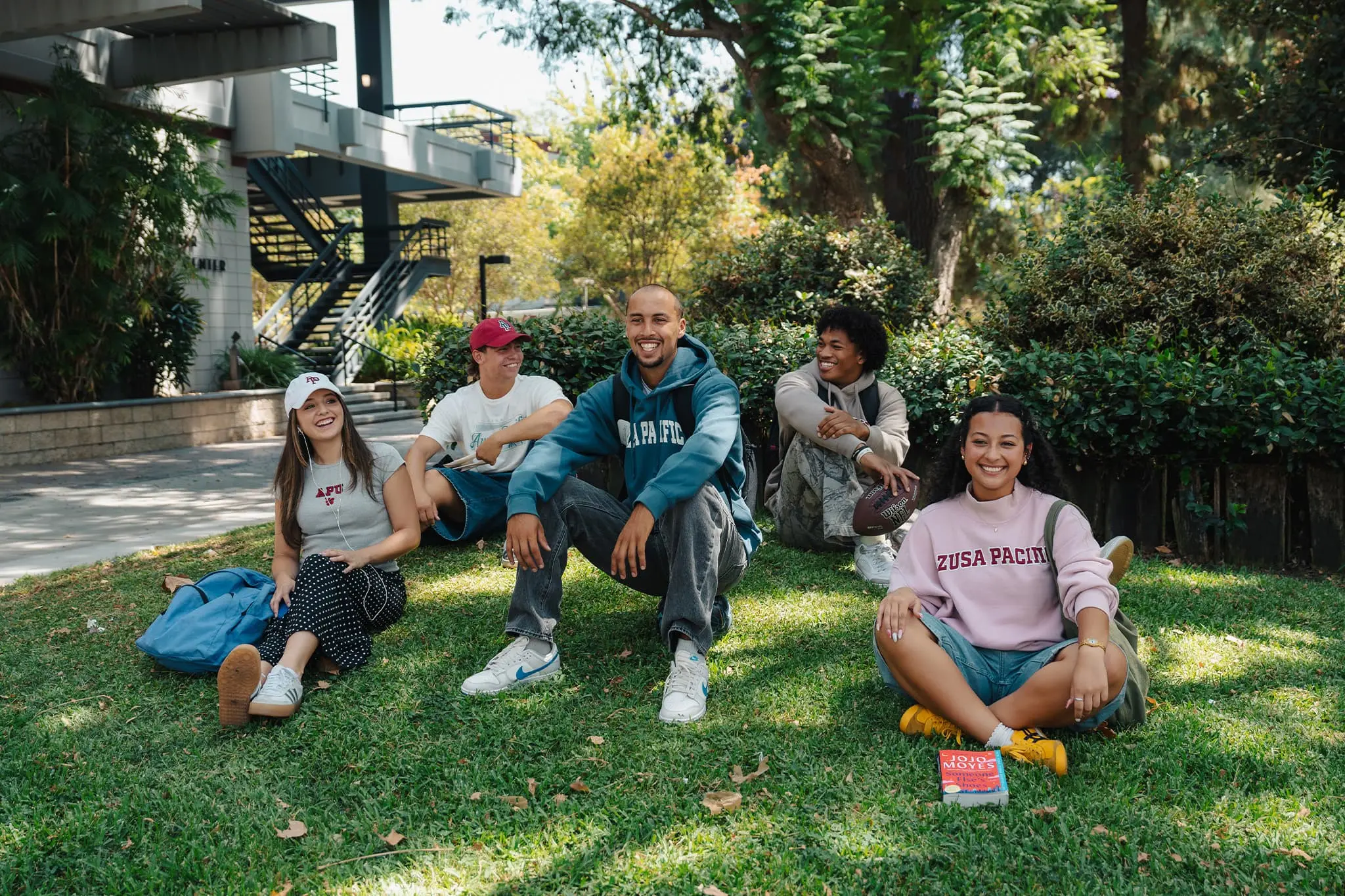 Students sitting on a lawn on East Campus