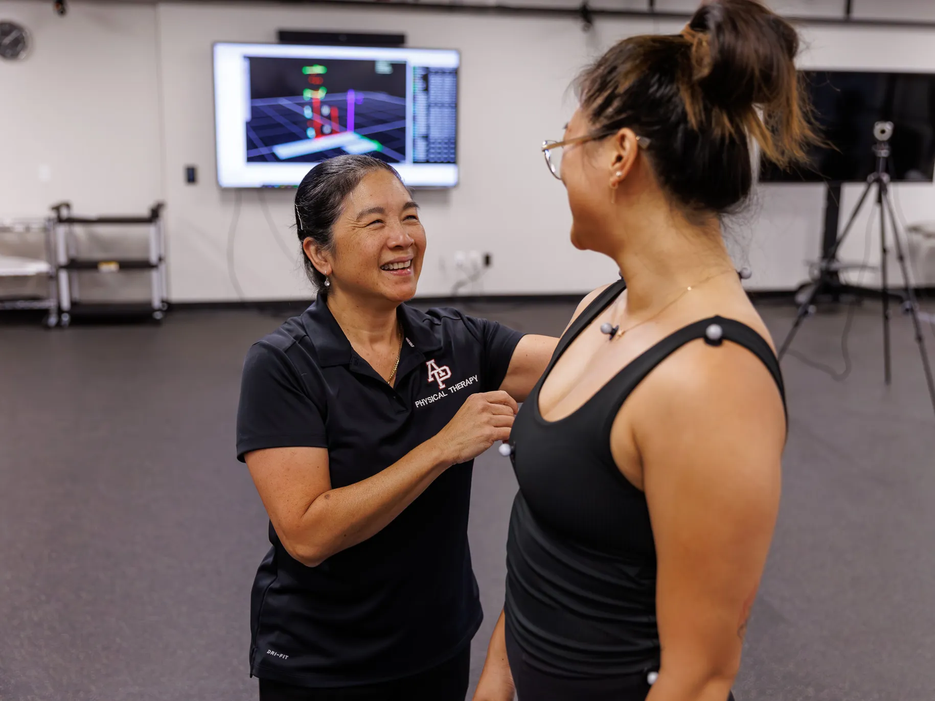 Annette Karim smiles at one of the dancers she works with as a physical therapist.