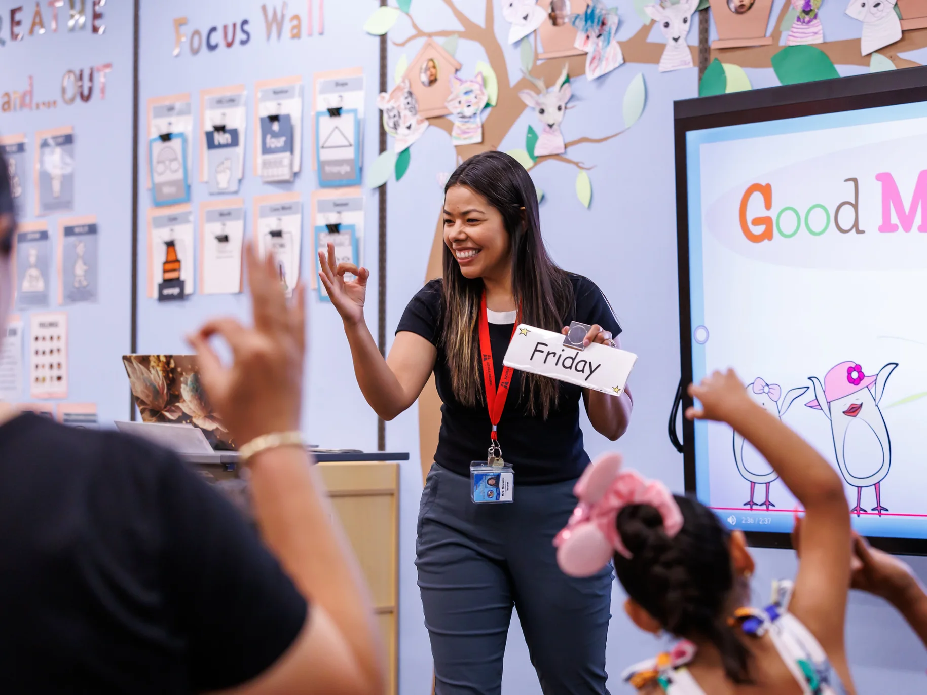 Diana teaches at the front of a classroom.