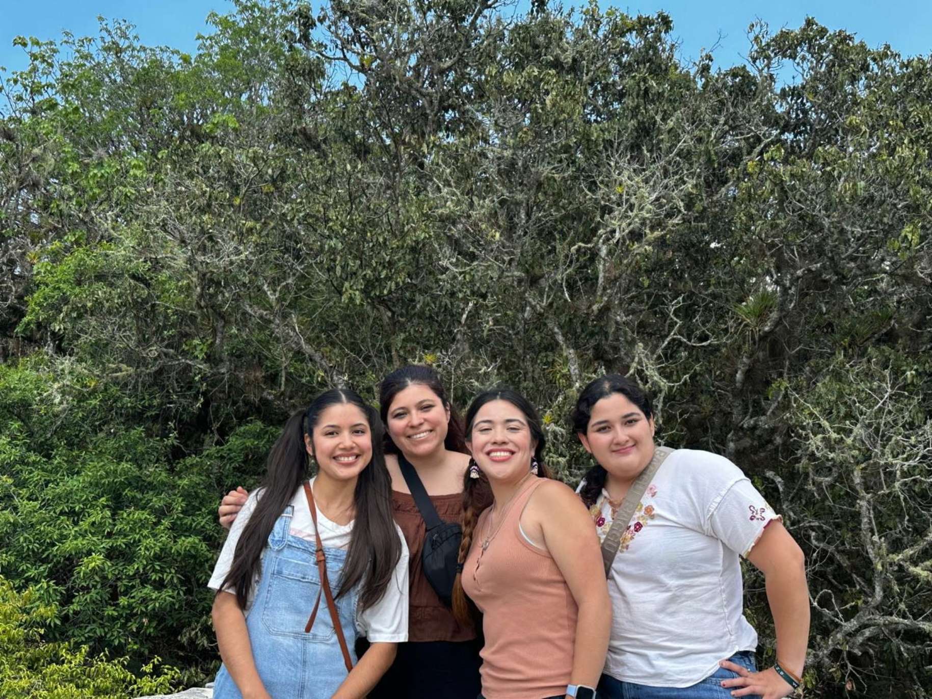 Segura and the Chiapas GE team smile in front of greenery.