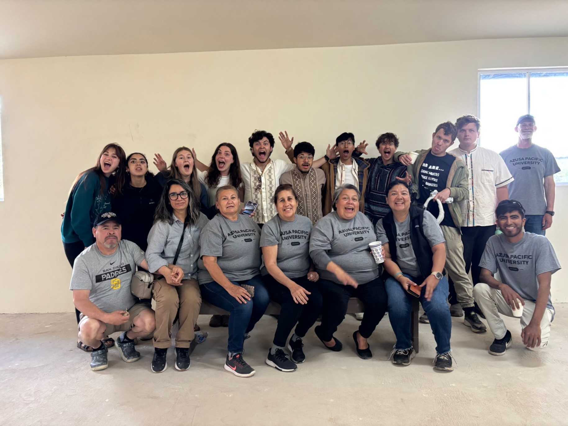 The Ensenada team takes a silly photo with workers from Lazarean Home Builds.