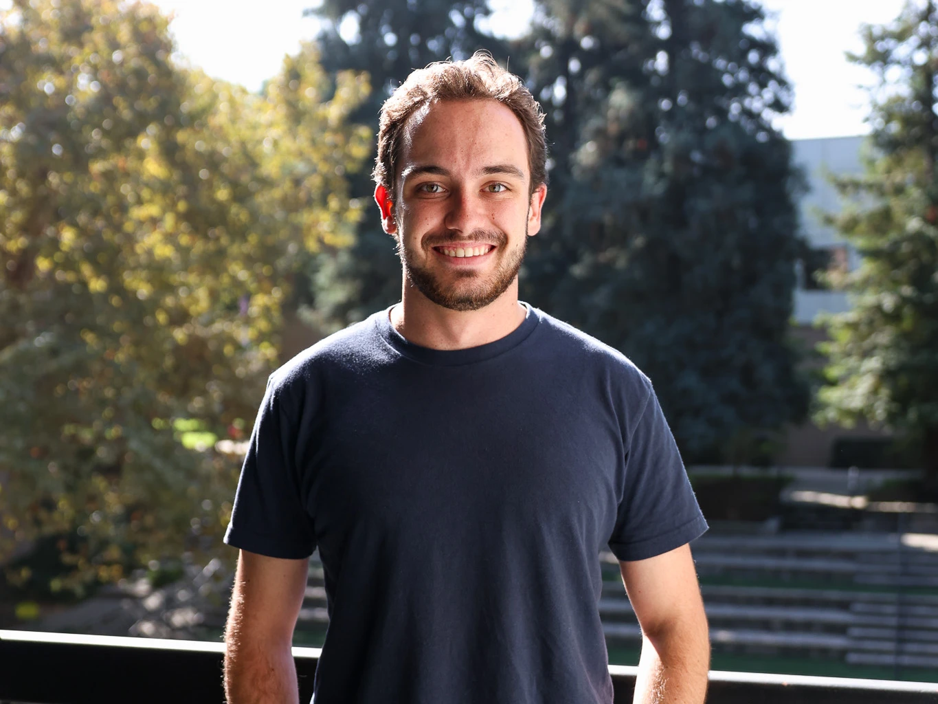 Luke Rockney smiles in front of the Wynn Ampitheater.