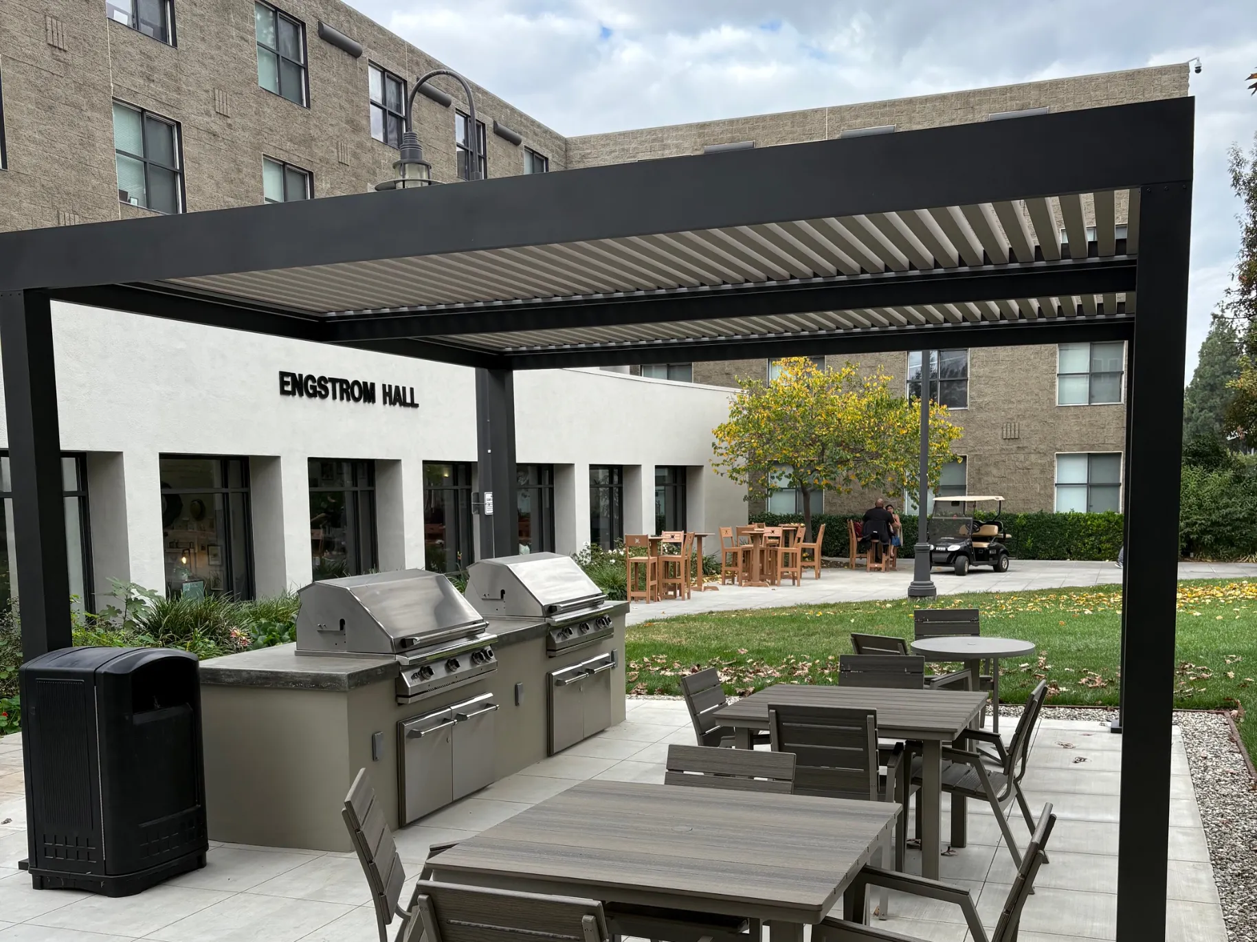 A new space in front of Engstrom Hall with two grills and tables.