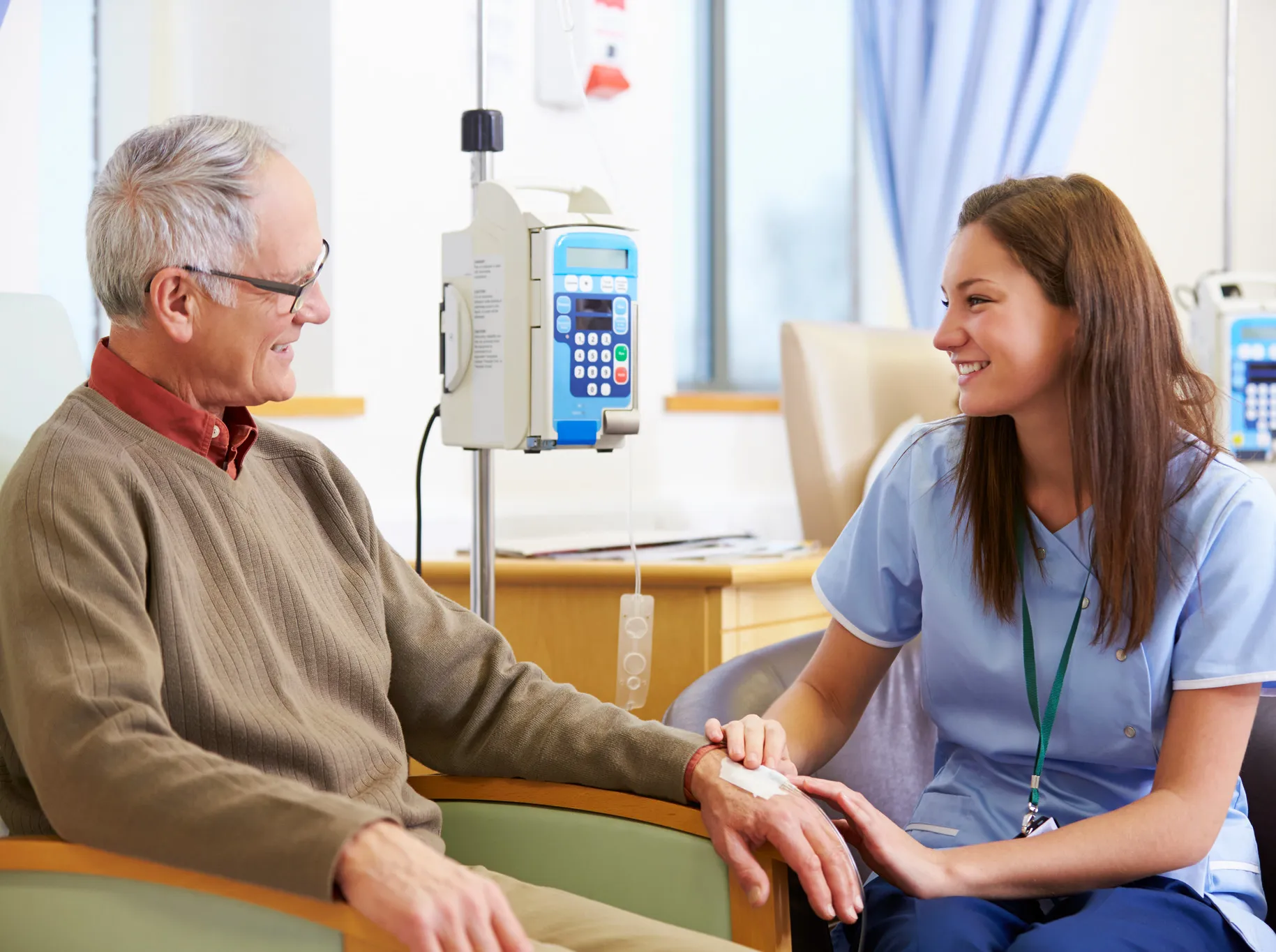 An oncology nurse talks to her patient.