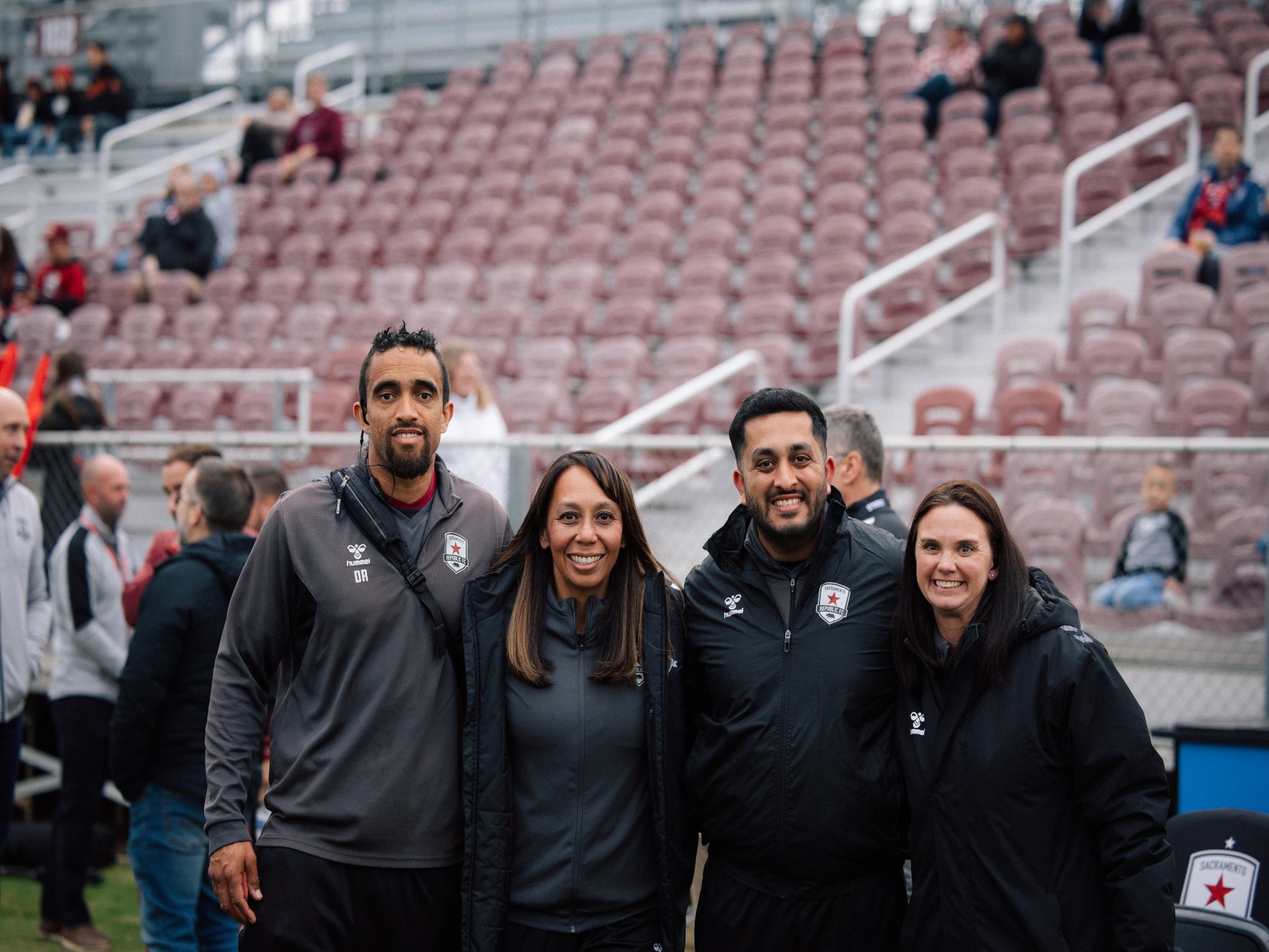 Rajan stands on the sidelines with Dave Redman ATC, CSCS, USAW, Charmaine Magale DC, CCSP, and Katy Norton, DPT, OCS from Sacramento Republic FC.