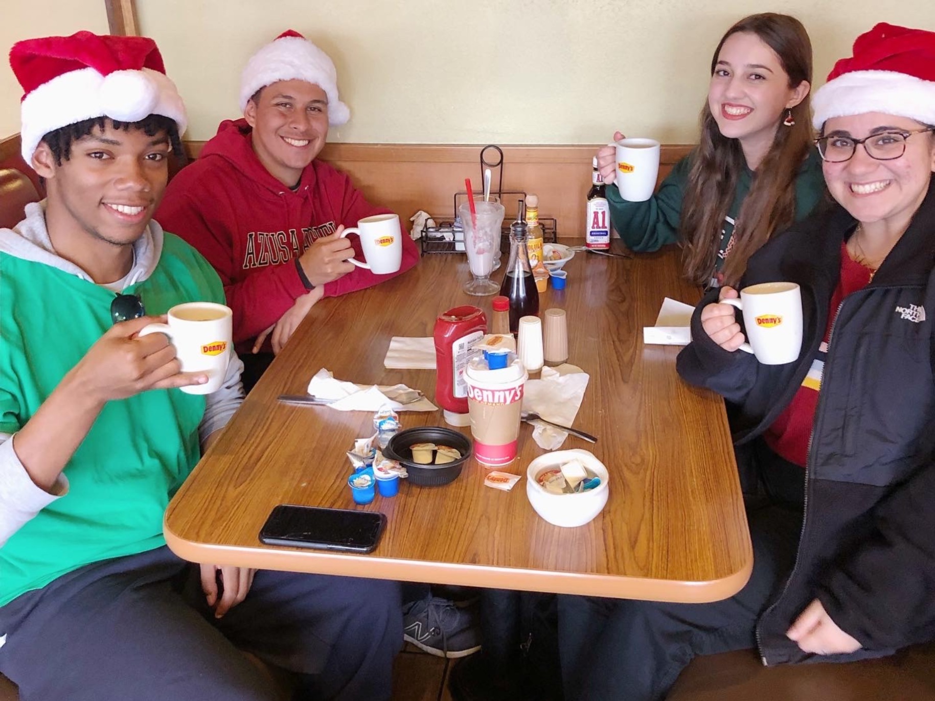 Saundri smiles with her writing group at Denny's