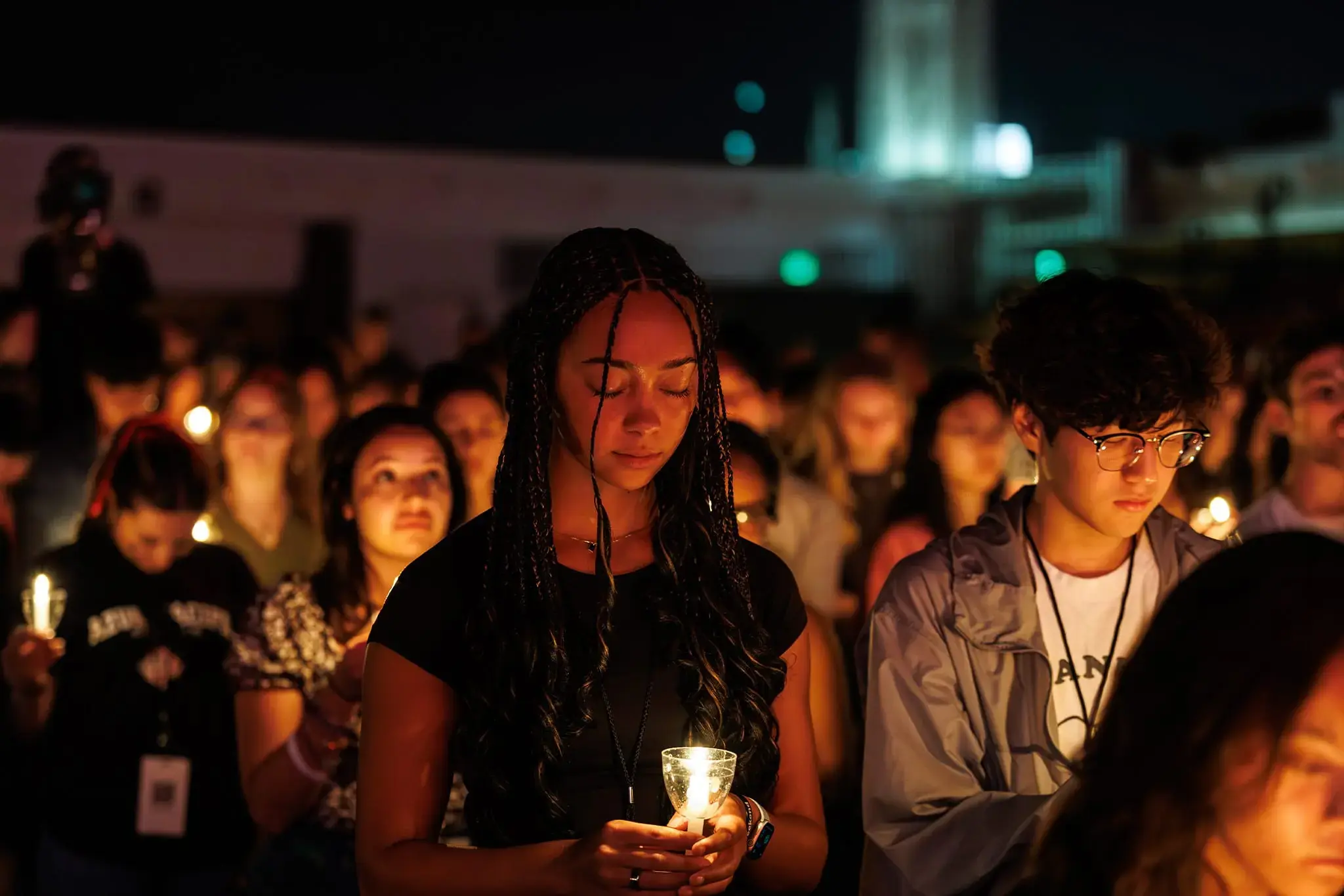 Student holding candle during Candela event