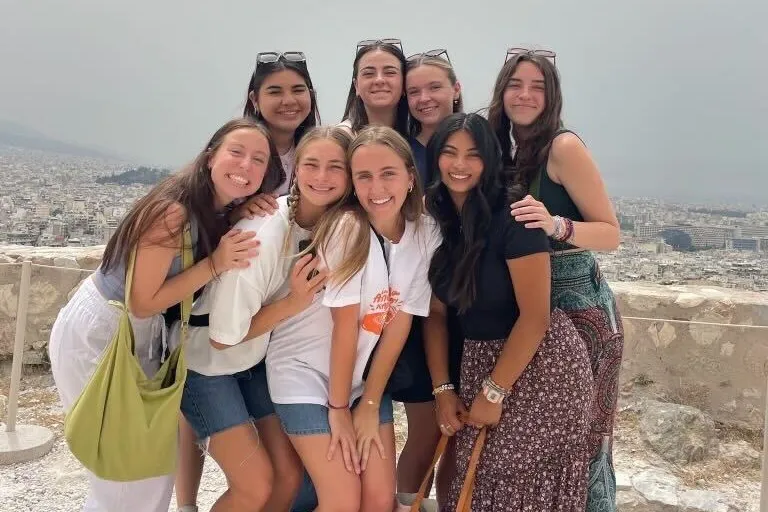 Adelaide and her global engagement team posing in Greece