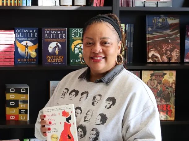 Nikki High smiling and holding a book
