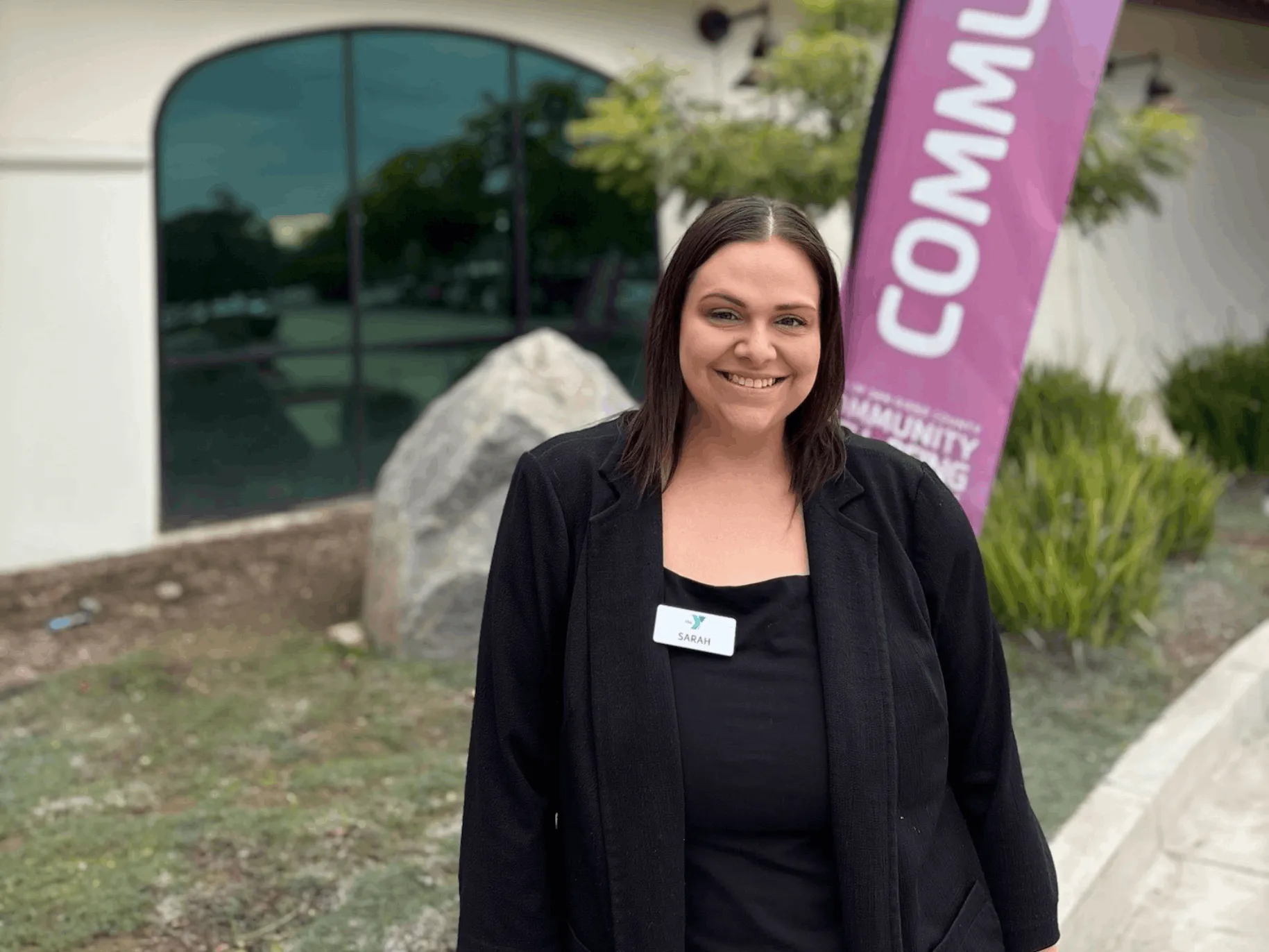 Sarah Adams ’11 standing in front of the McGrath Family YMCA.