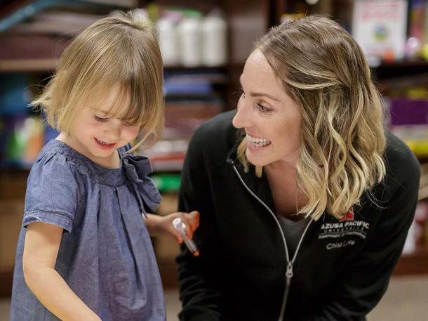child and teacher in the classroom