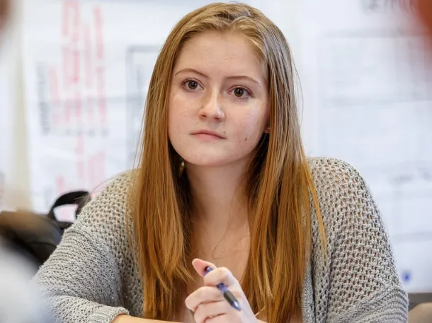 student listening to professor during class