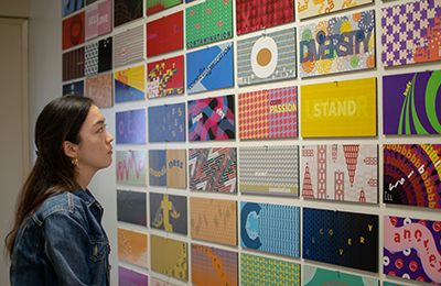 student looking at design elements on the wall