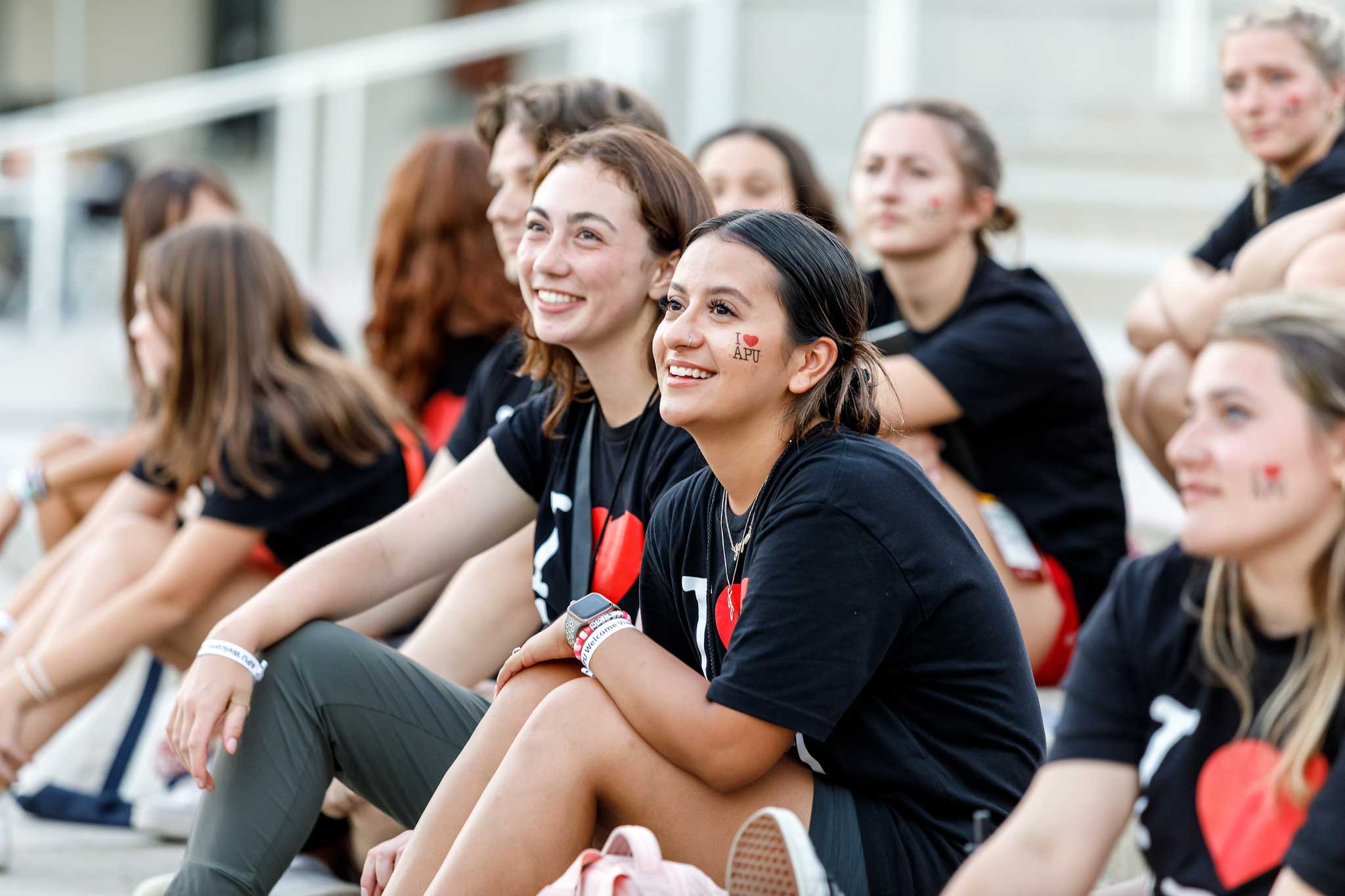 students wearing black t-shirt and smilling