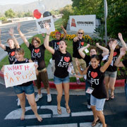 Students in I HEART APU shirts cheering