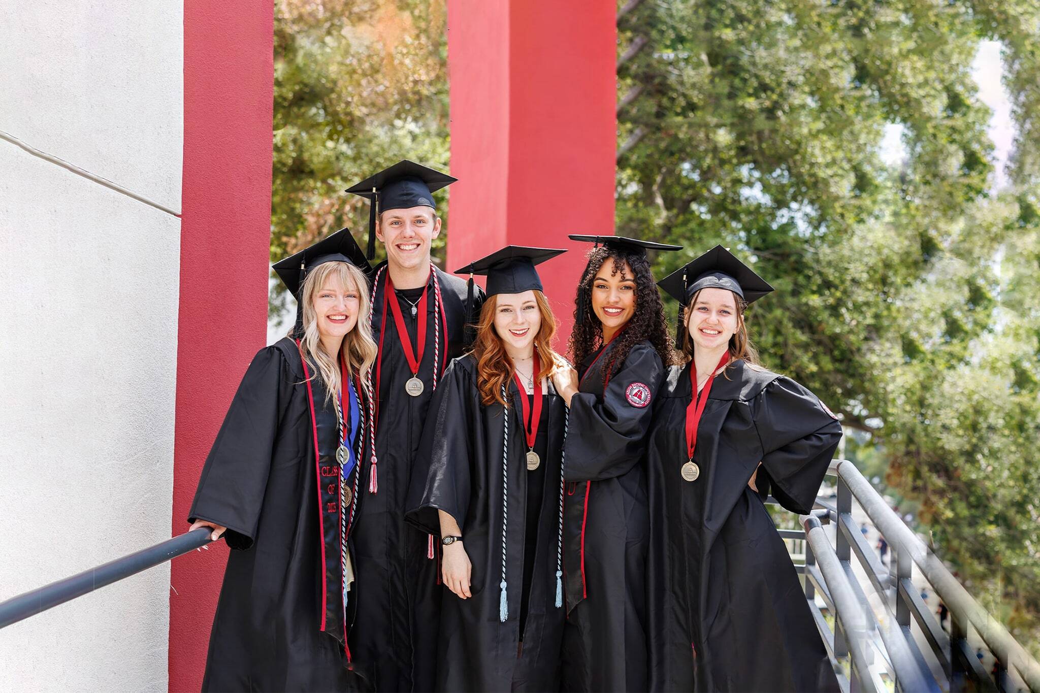apu students wearing black cap and gown
