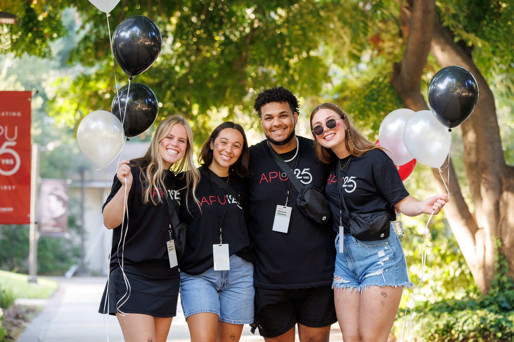 students smiling with black t-shirts