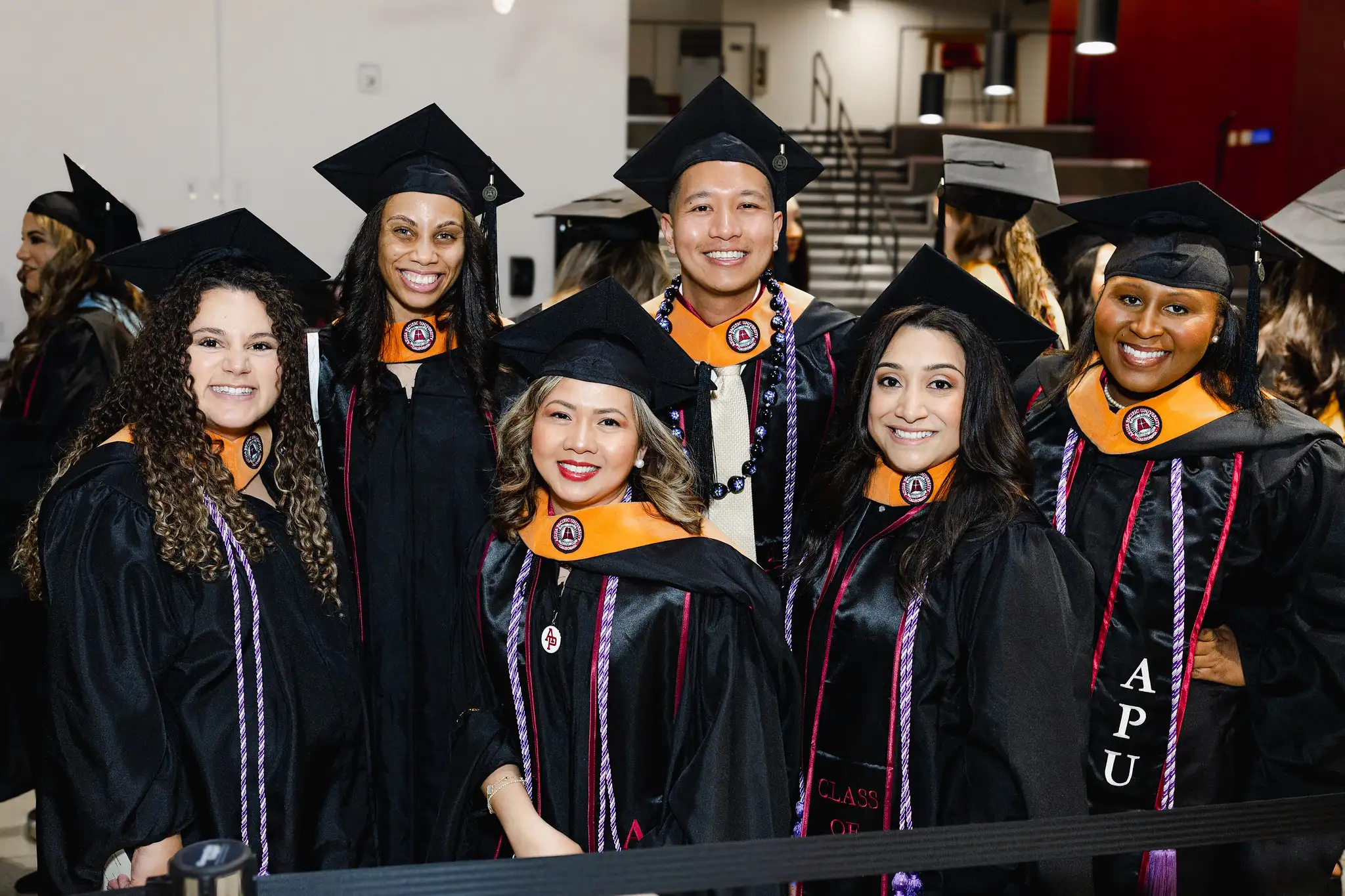 students during commencement wearing cap and gown