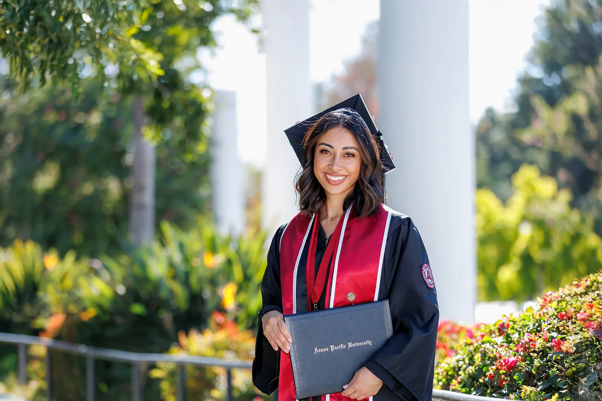students during commencement wearing cap and gown