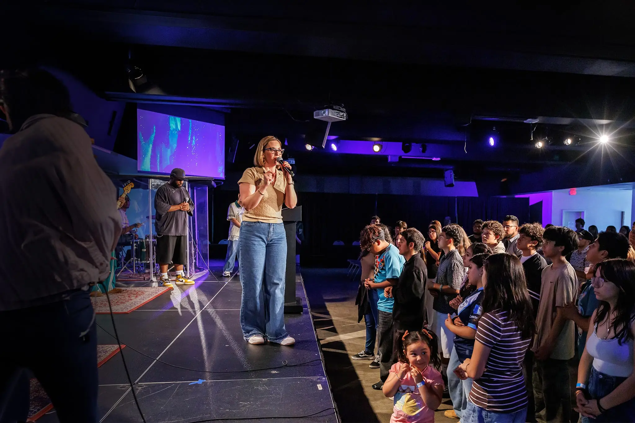 Student singing on stage