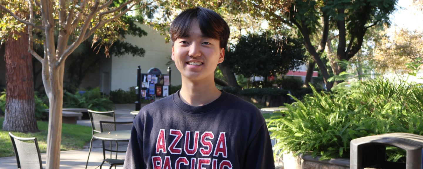 student Heejae Jeongs on campus wearing apu’s sweater