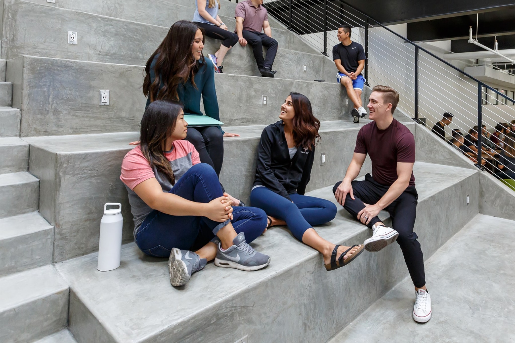 students hanging out and smiling in west campus