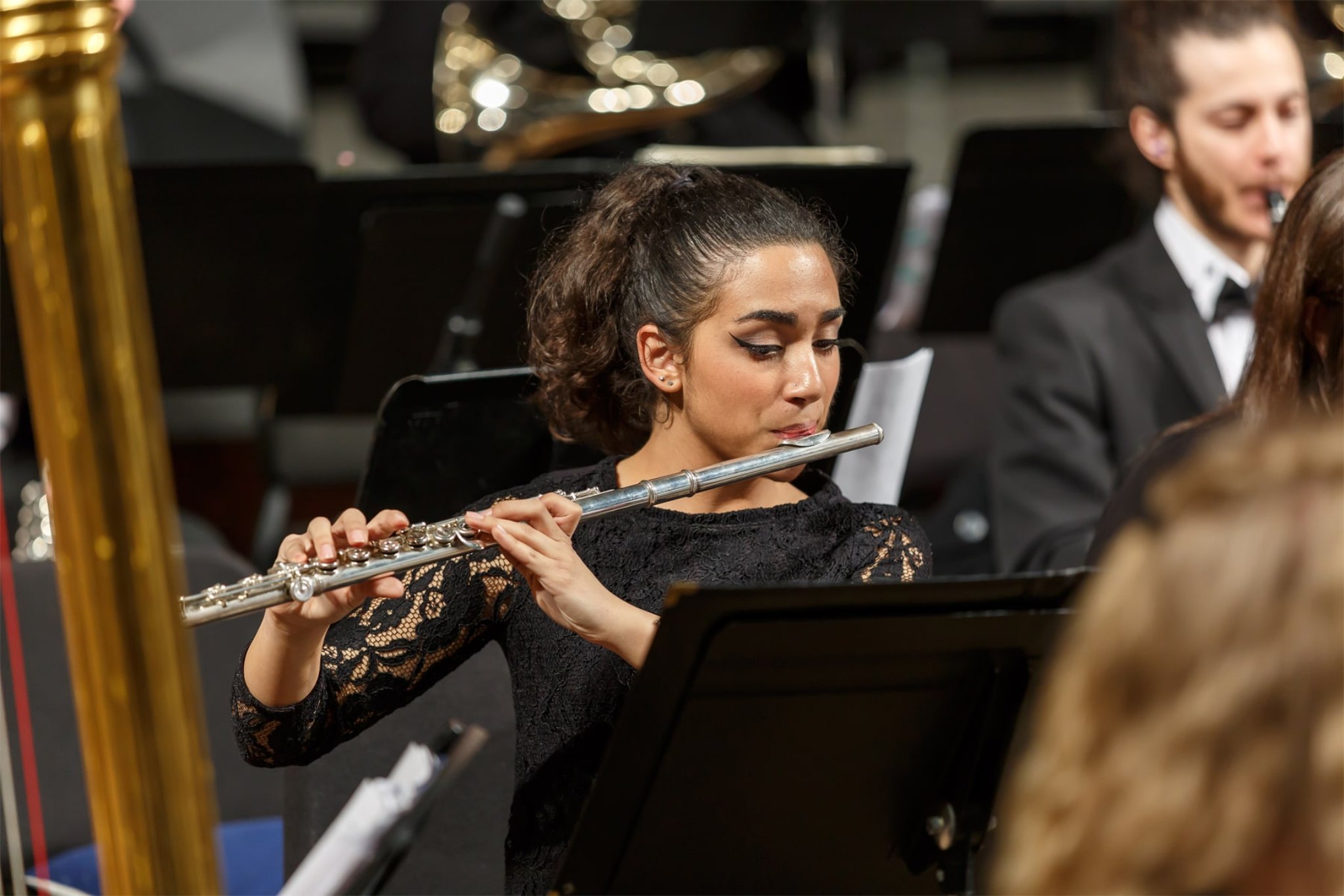 student playing the flute during orchestra performance