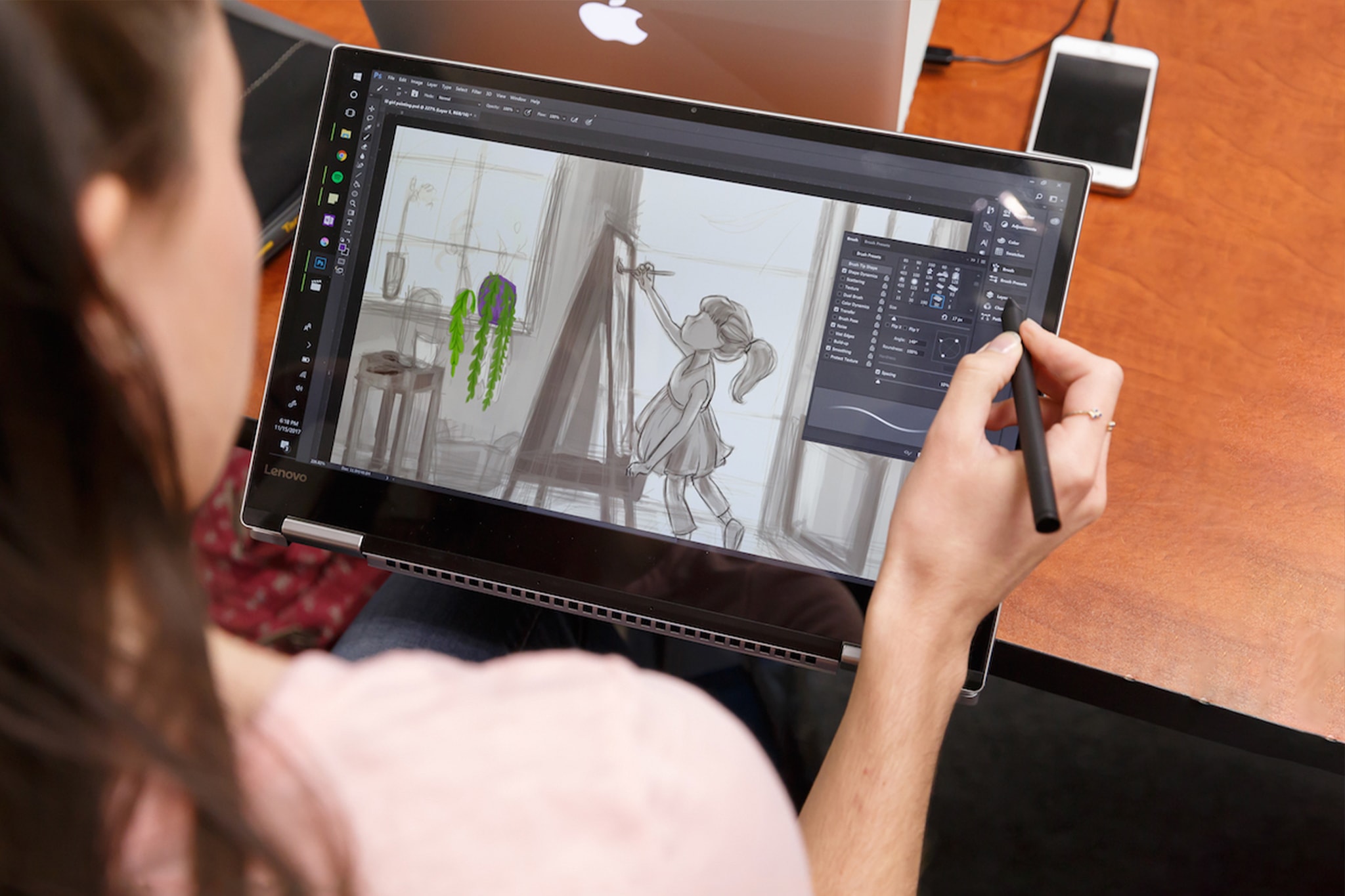 student drawing using her tablet