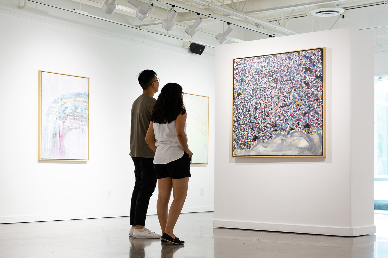 couple looking at an art piece on the wall