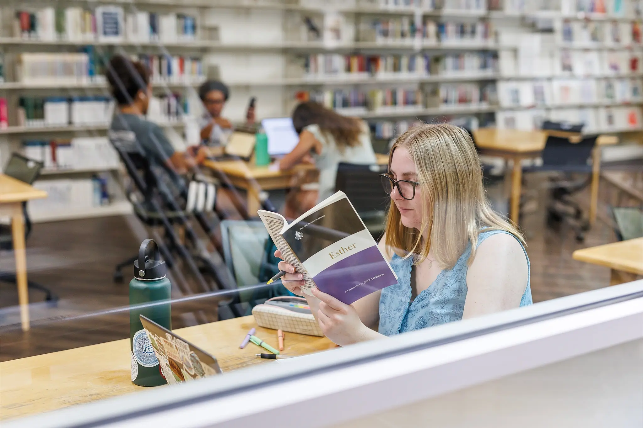 Student reading the Book of Esther at a Stamps Library study table
