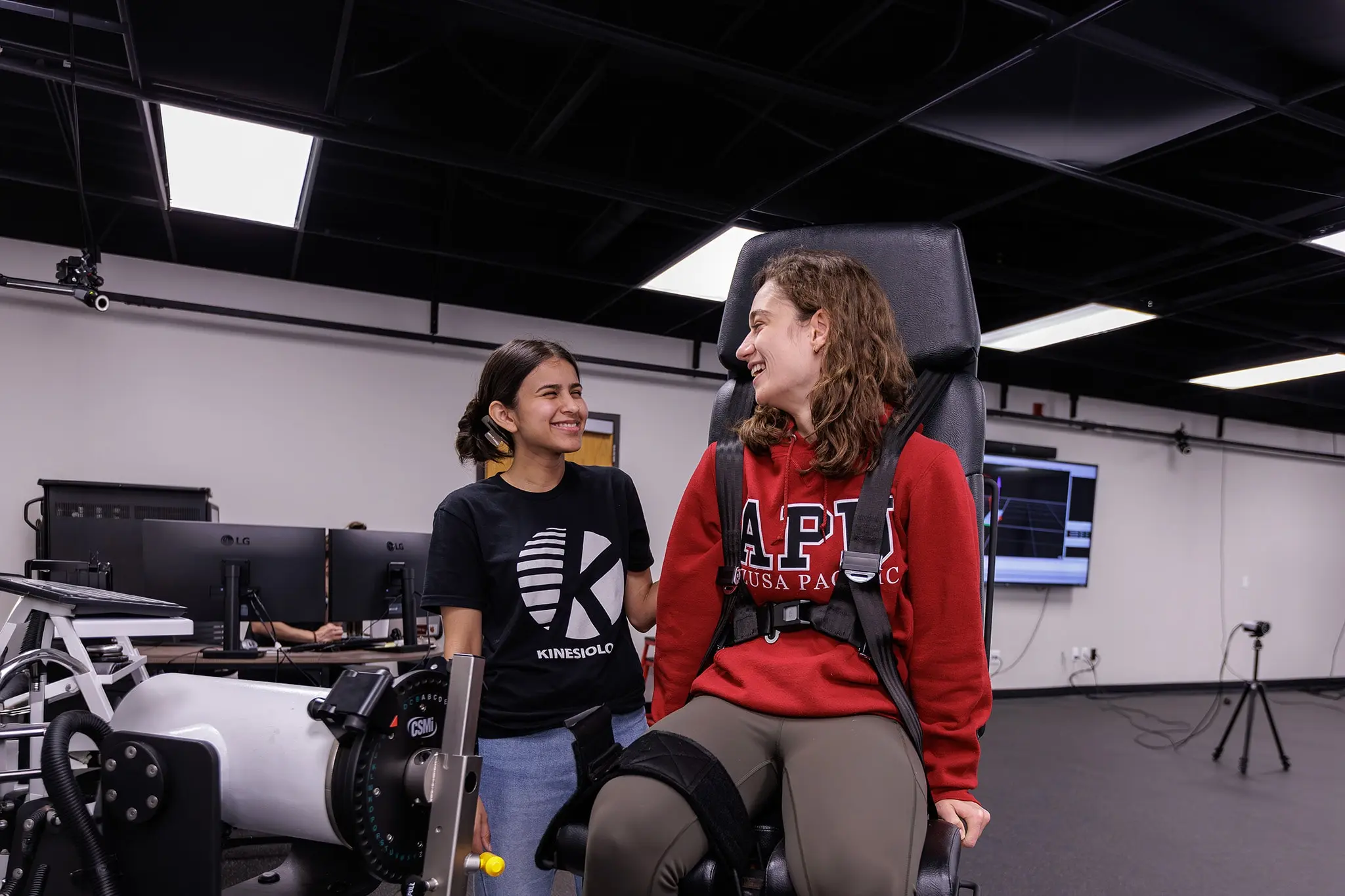 student doing an exercise during class with a mechanical chair