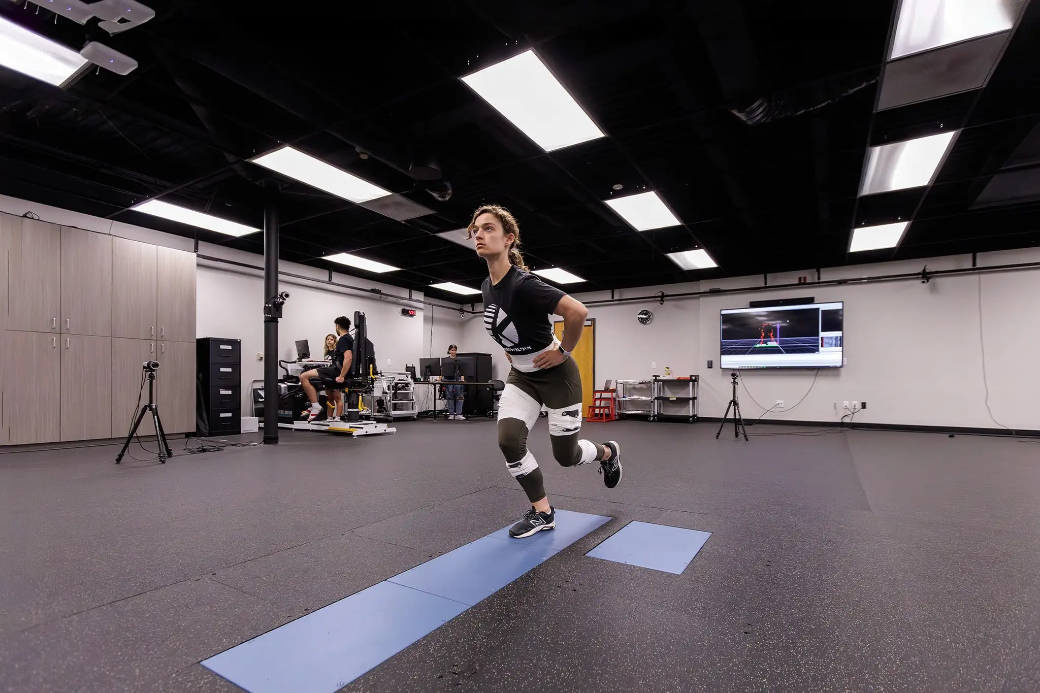 student doing an exercise during class with resistance band