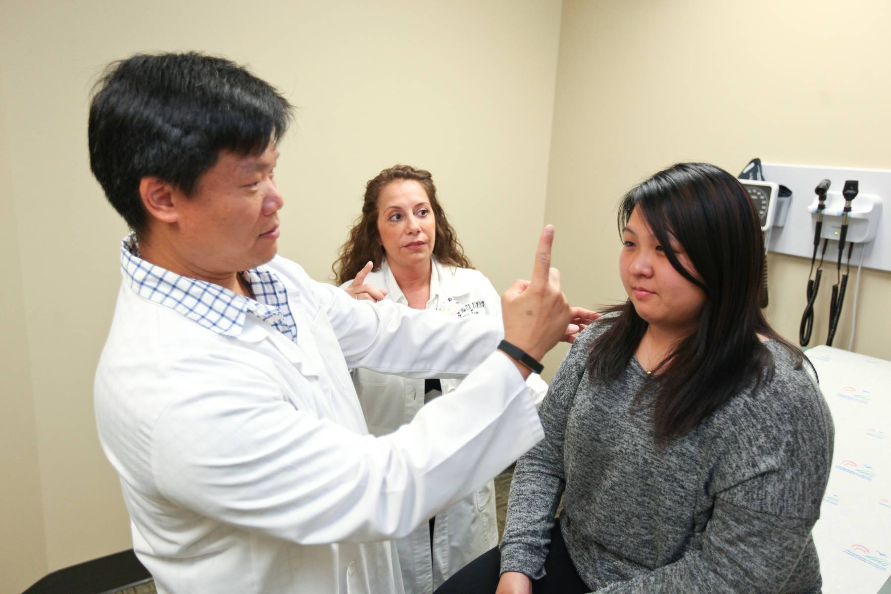 doctor checking students vision in class