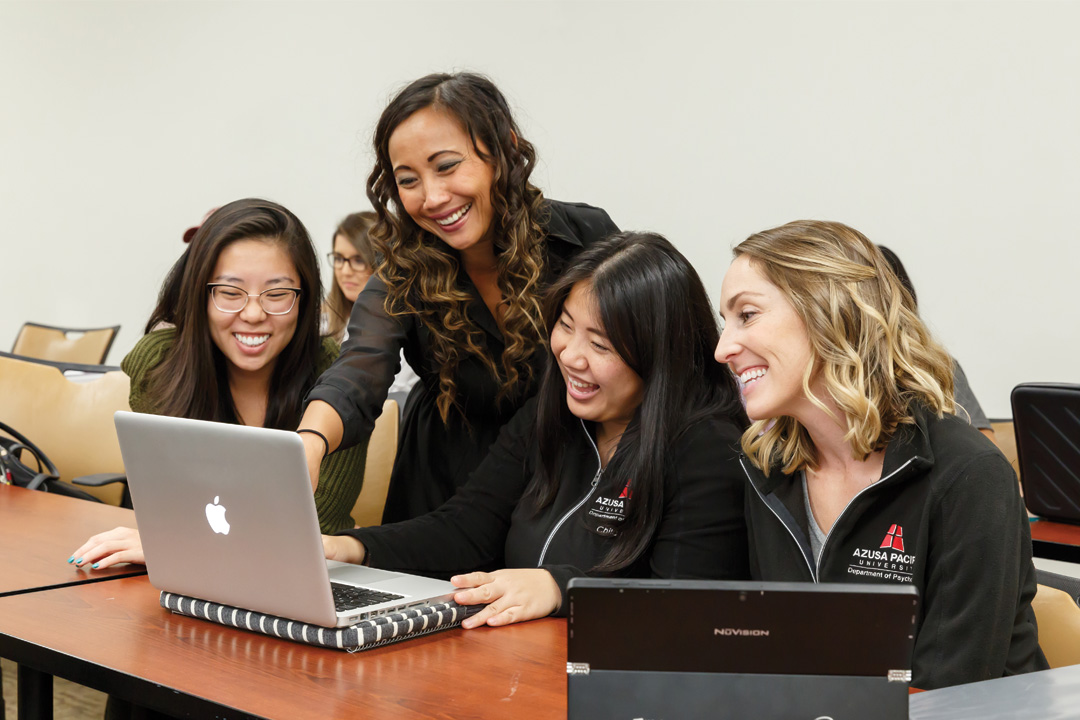 Students surrounding a laptop