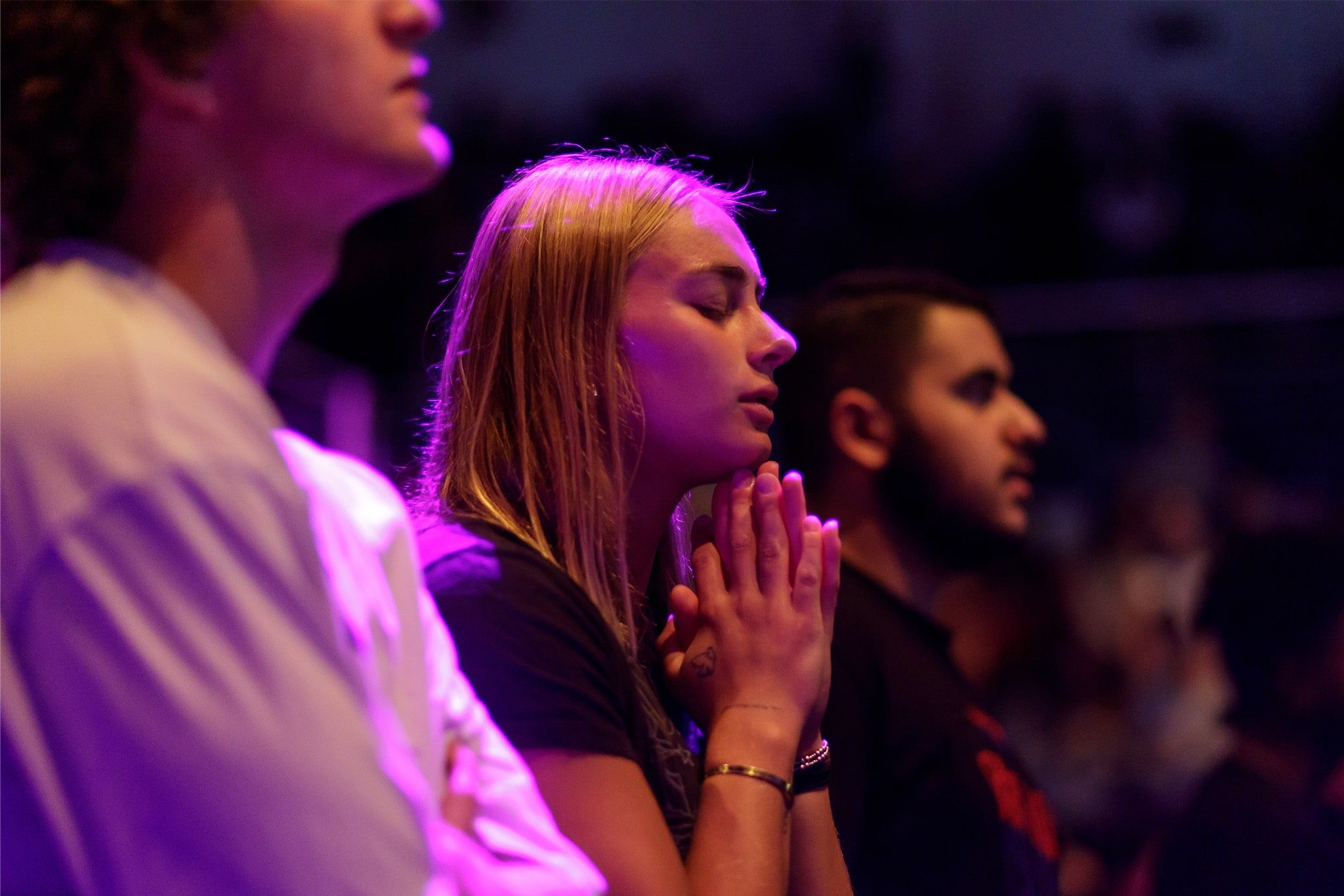 Student worshipping in chapel