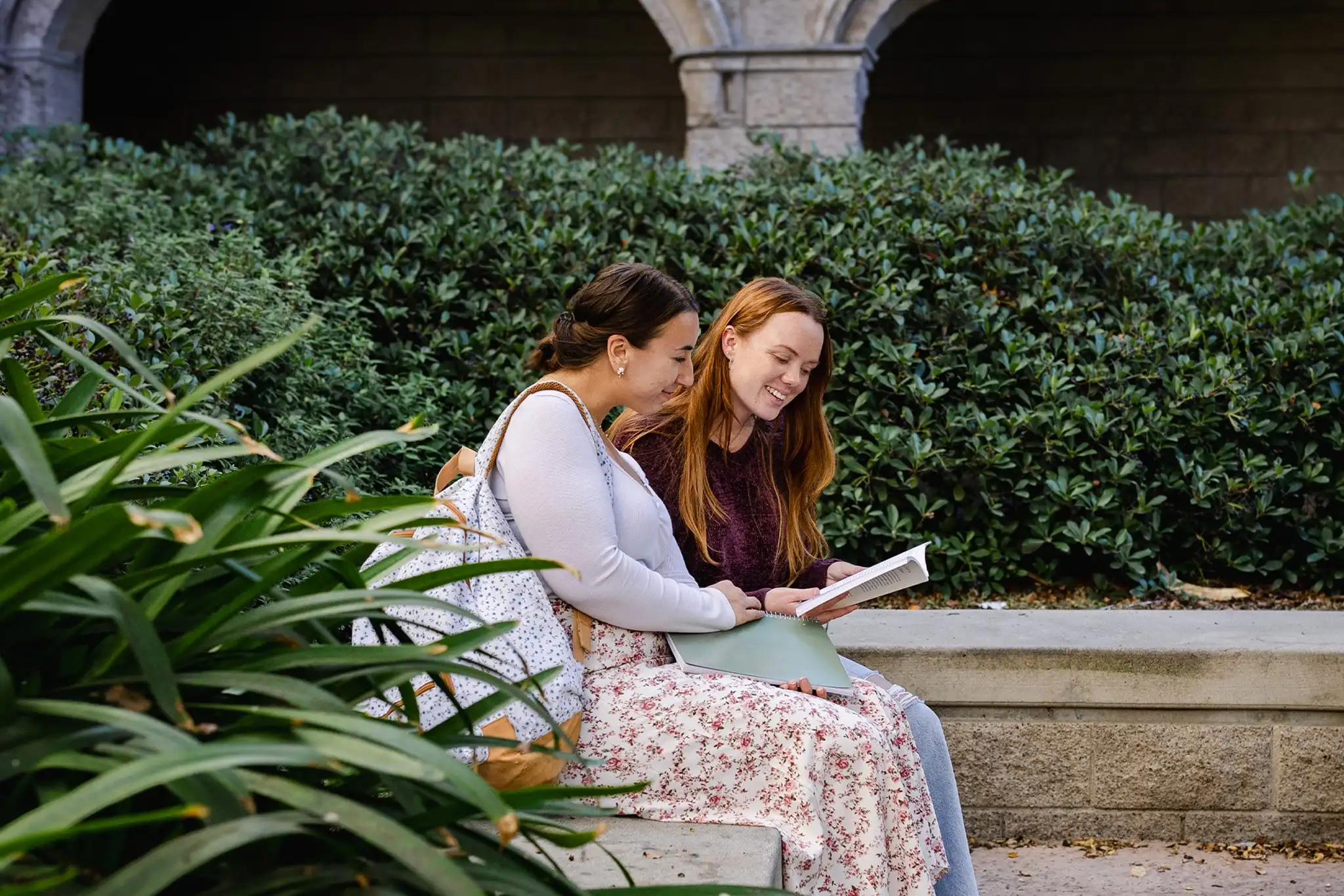 student sitting on campus and talking