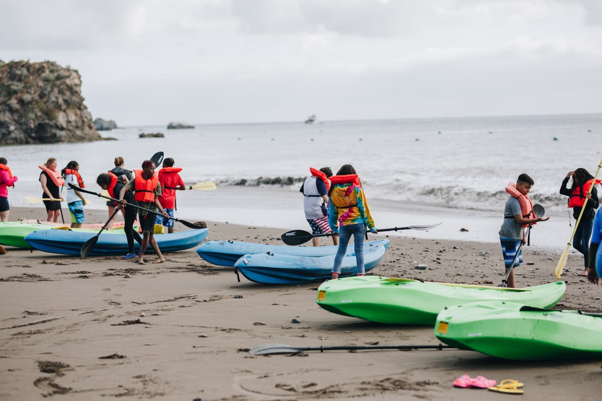 People in kayaks at shoreline