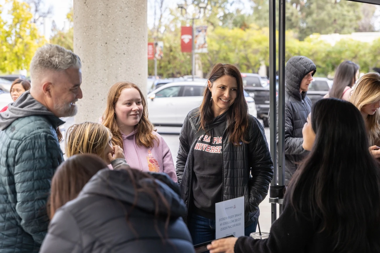 student and her family listening to apu‘s staff