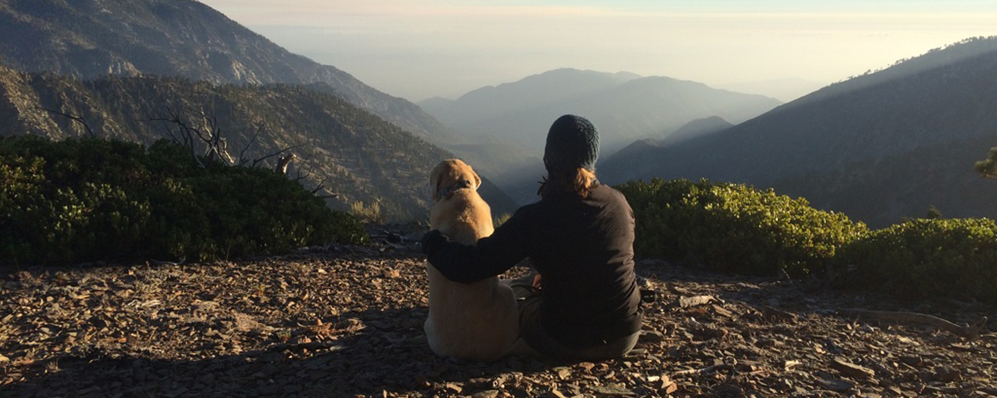 Sonya Wilson sits with her hearing dog, Stacy, on top of Mt. Baldy.