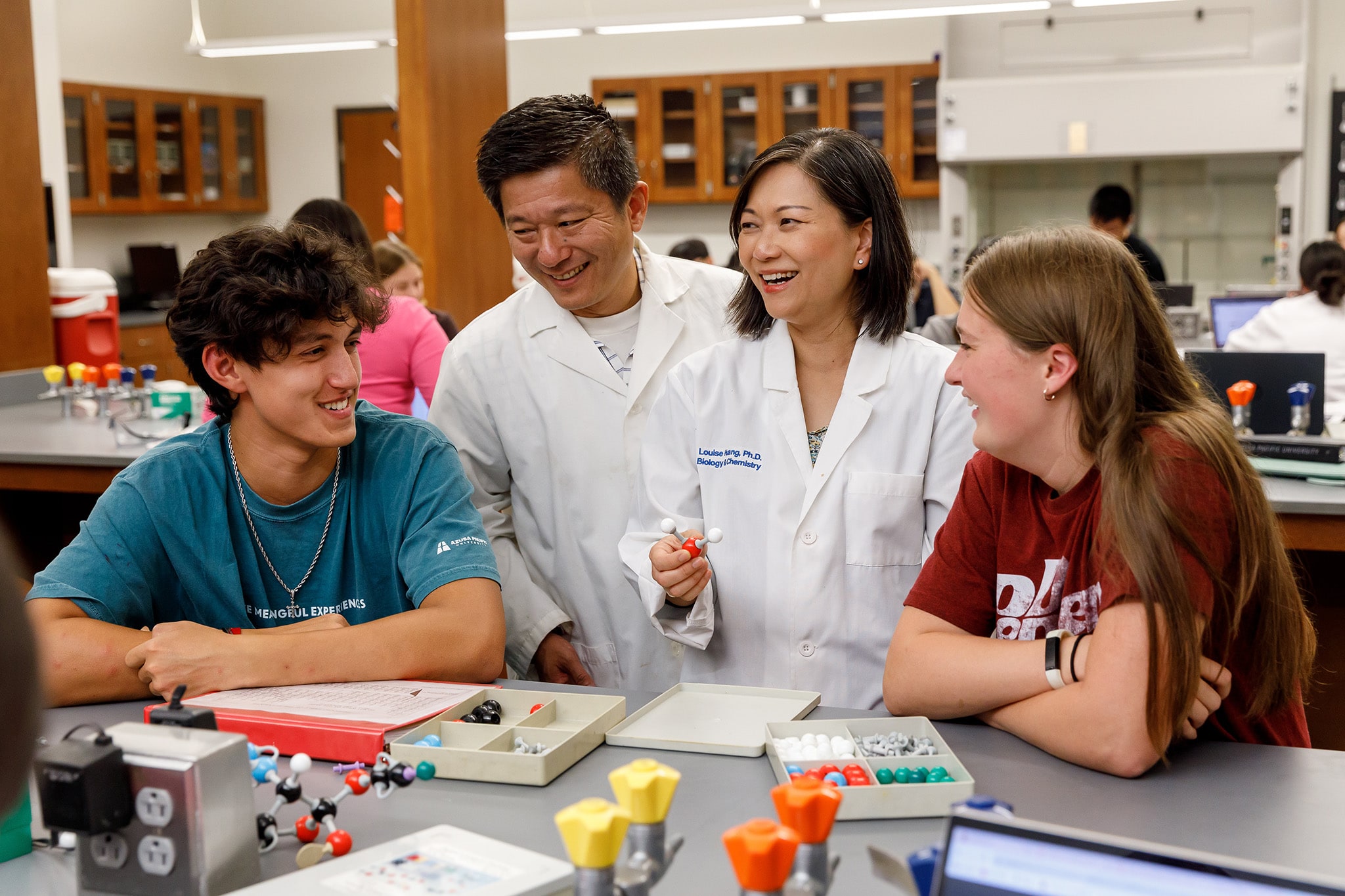 Mr. and Mrs. Huangs teaching students on a class room